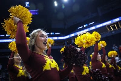 Cheerleaders perform at a basketball game