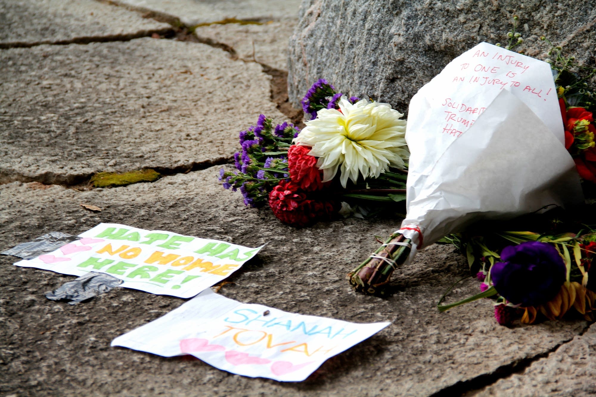 Flowers are left at the site of anti-Jewish and pro-Donald Trump graffiti.
