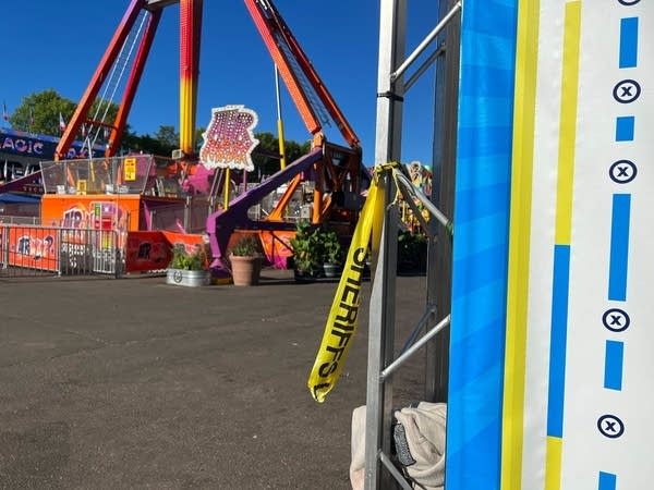 Yellow police tape tied to a post