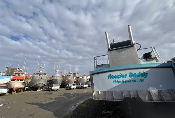 A boat with the name Hoosier Daddy sits out of the water. It is from Indiana.