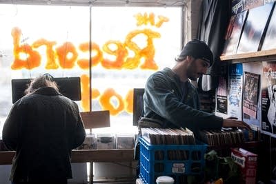 People browse records in a record store