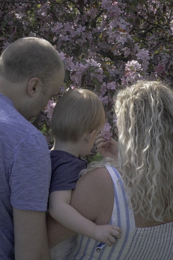 family looks at flowers