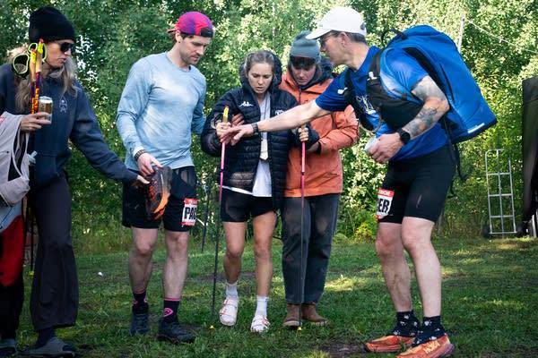 Jessie Diggins stands up with the support of her crew
