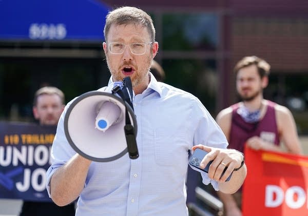 A man speaks into a megaphone.