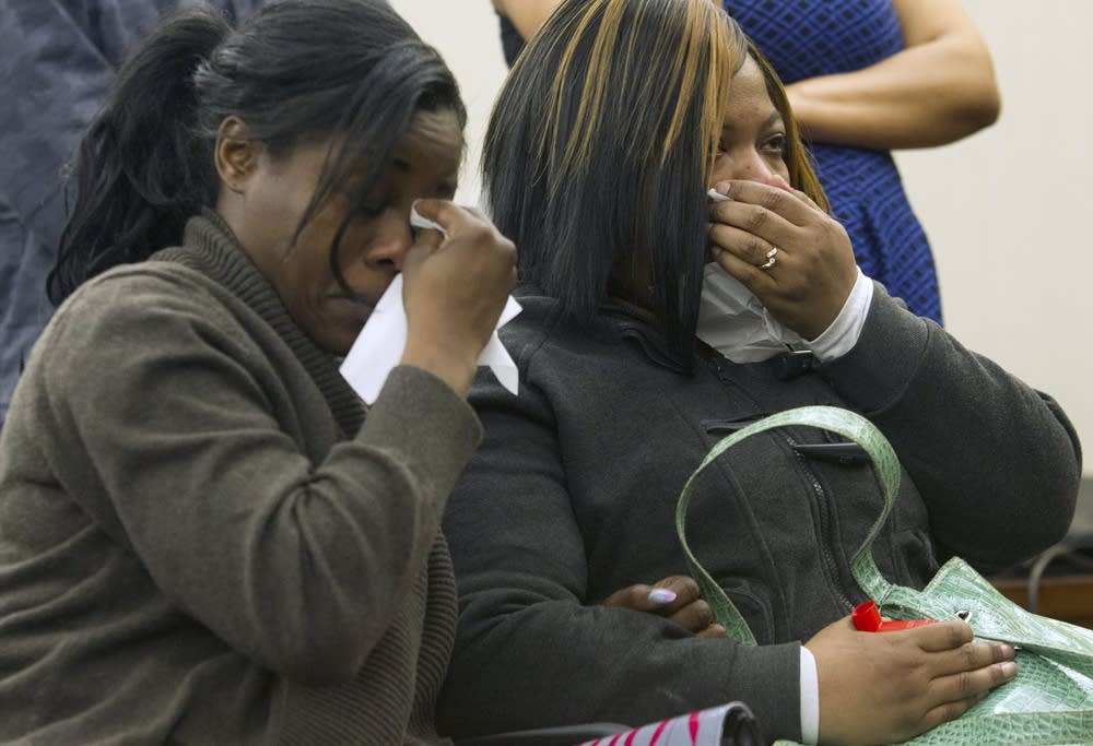 Jamar Clark's sisters watch a video.