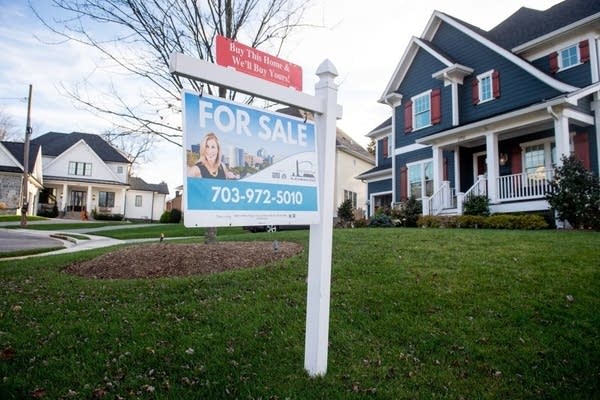 A house's real estate for sale sign is seen in front of a home in Arlington, Virginia, November 19, 2020. 