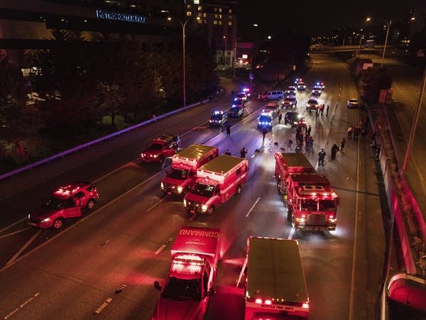 Emergency personnel work at a crash scene