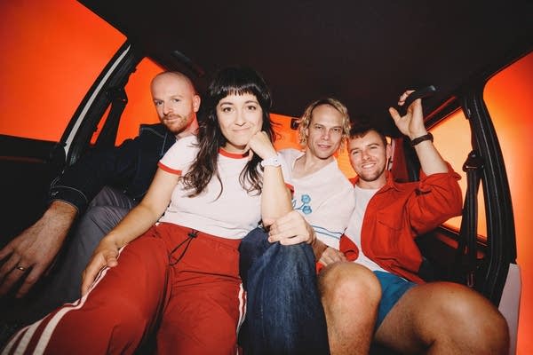 Four people cram into the backseat of a car for a fun portrait