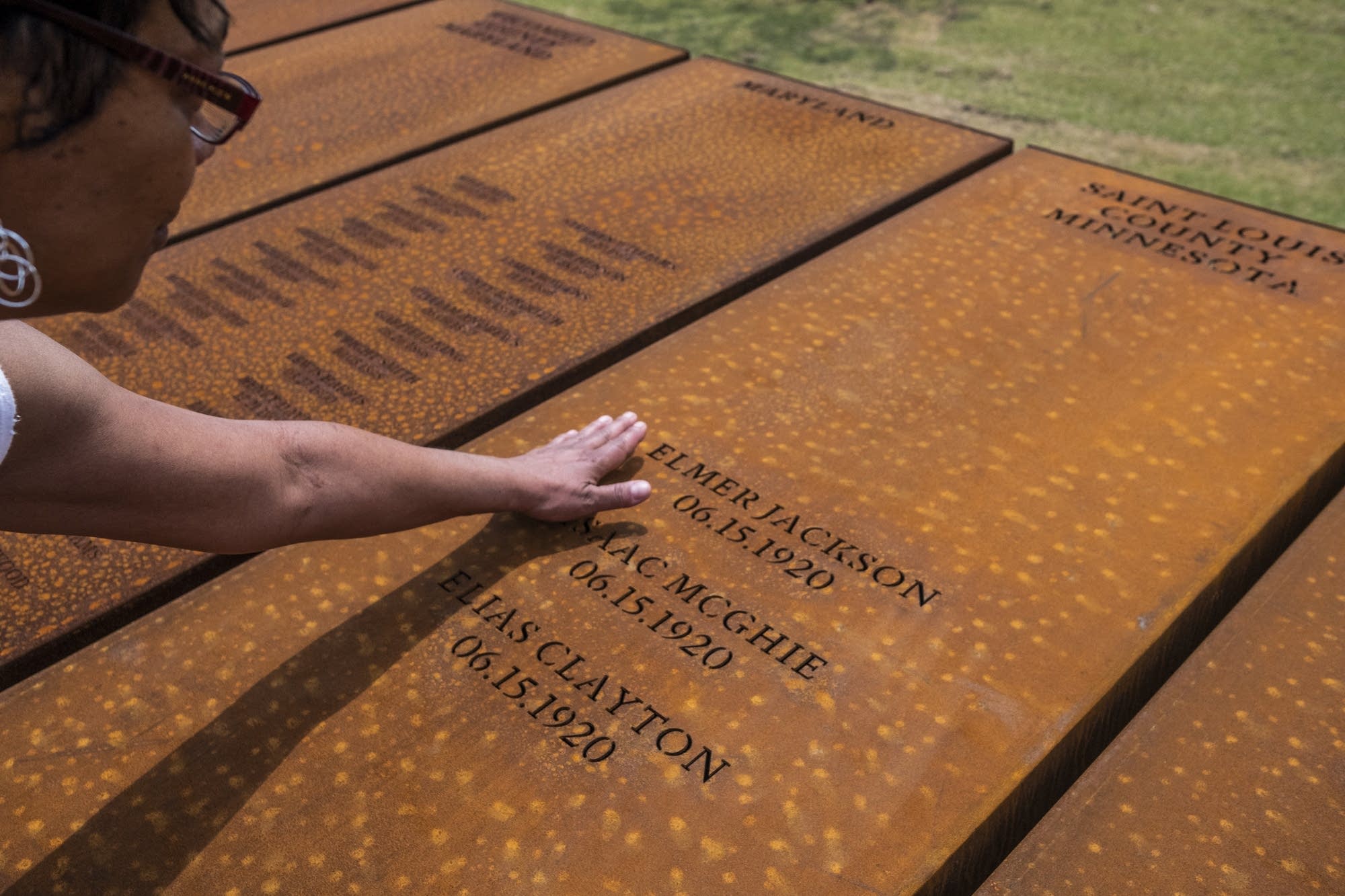 Kim Green touches the names of the three men lynched in Duluth in 1920.
