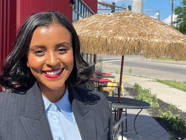 A woman outdoor restaurant smiles at the camera