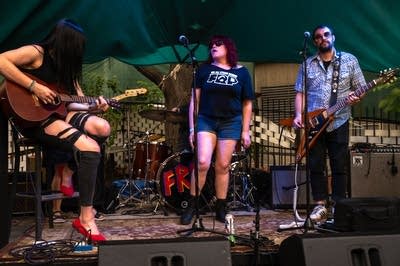 a rock band performing on an outdoor stage