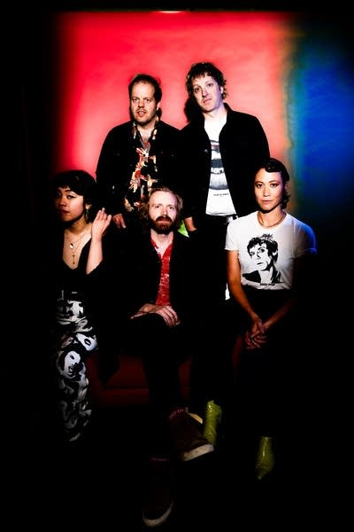 Five people pose for a studio portrait