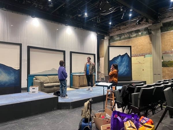 people rehearse a play on a stage