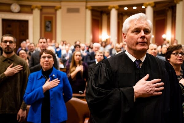 Justice Paul Thissen says the pledge of allegiance.