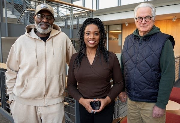three people posing for a portrait