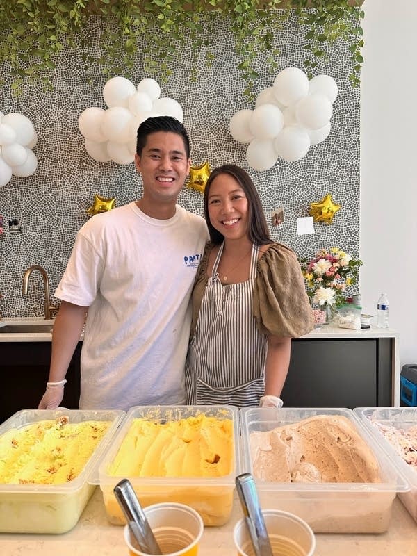 Two people smile and pose