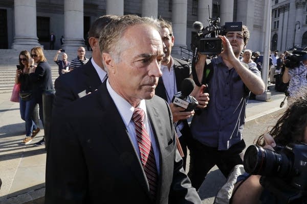 A man in a suit leaves a court building