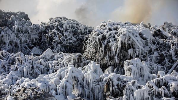 A pile of ice-covered cars. 