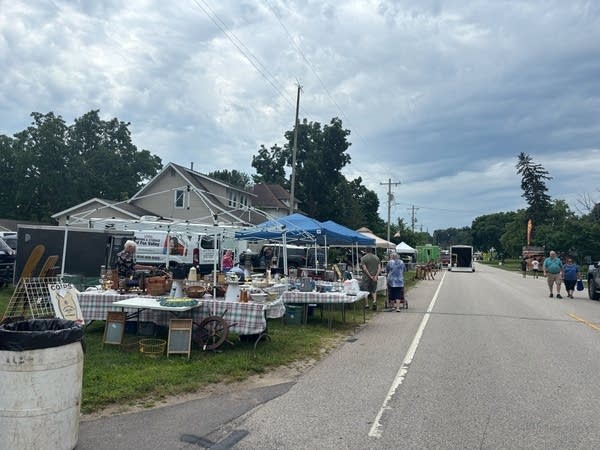 Wide shot of a street lined with vendor booths.
