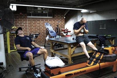 Two men catch their breath during a workout.