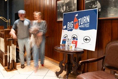 Big Turn sign and blurry image of two people
