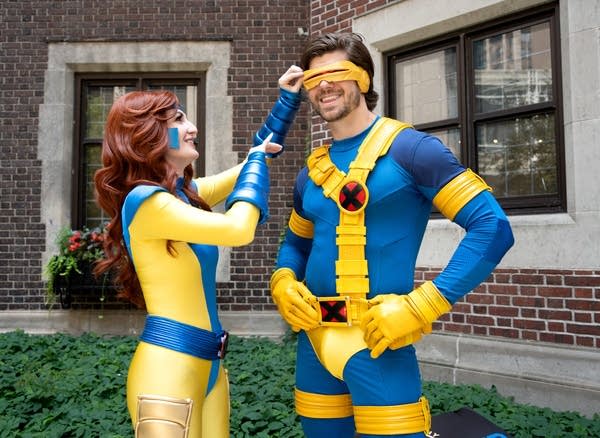 two people dressed in cosplay pose as they get their photo taken