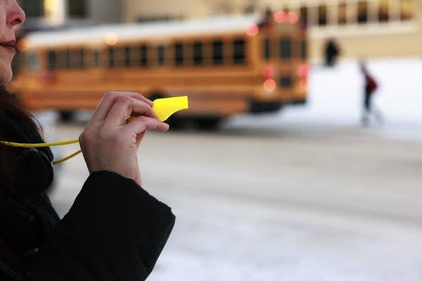 A volunteer holds up a whistle