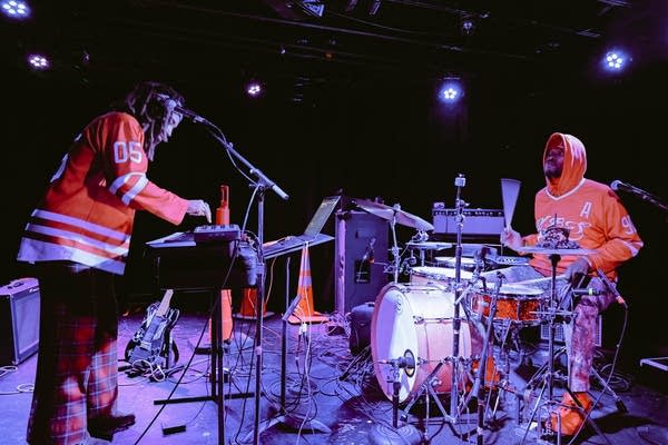 Two musicians performing onstage