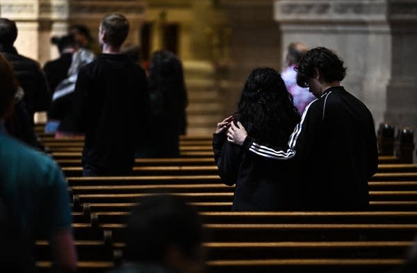 People stand in a pew