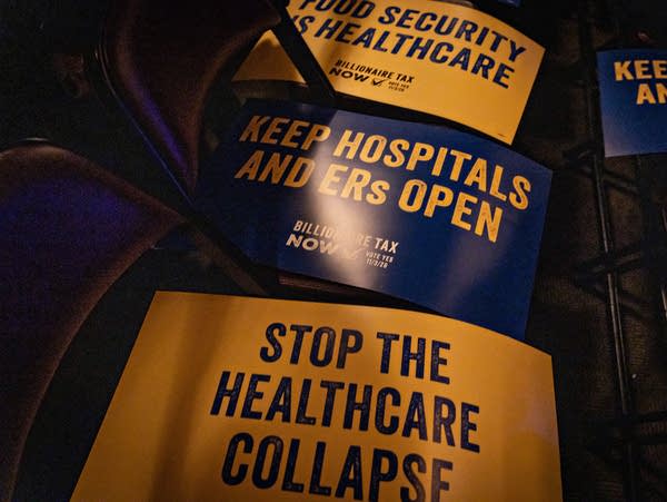 A sign reads "Stop the healthcare collapse."