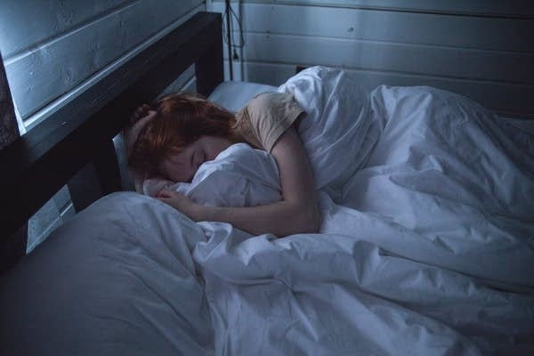 A woman asleep in bed.