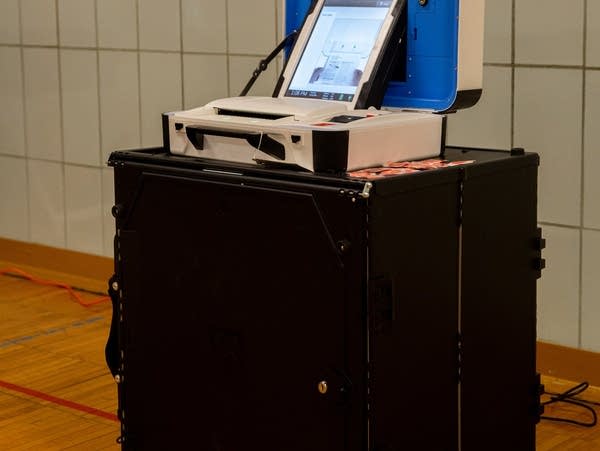 A black box with a computer like device on top.