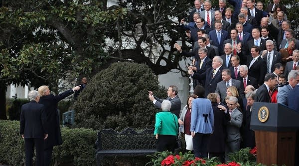 U.S. President Donald Trump and Senate Majority Leader Mitch McConnell acknowledge Republican members of the House and Senate at the conclusion of an event celebrating the Tax Cuts and Jobs Act on the South Lawn of the White House December 20, 2017 in Washington, DC. The tax bill is the first major legislative victory for the GOP-controlled Congress and Trump since he took office almost one year ago.