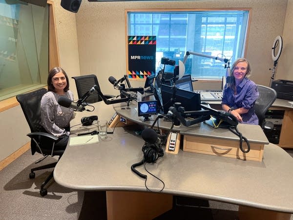 two women smiling in a broadcast studio