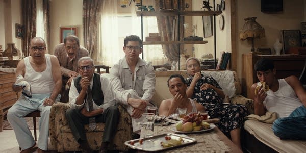 Multiple people sitting in a room together
