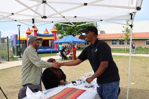 Men shake hands.