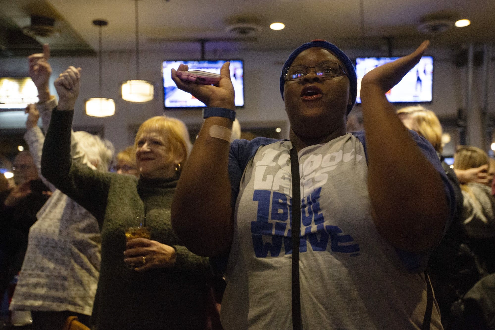 Sasha Williams celebrates as Democrats take control of the Minnesota House.
