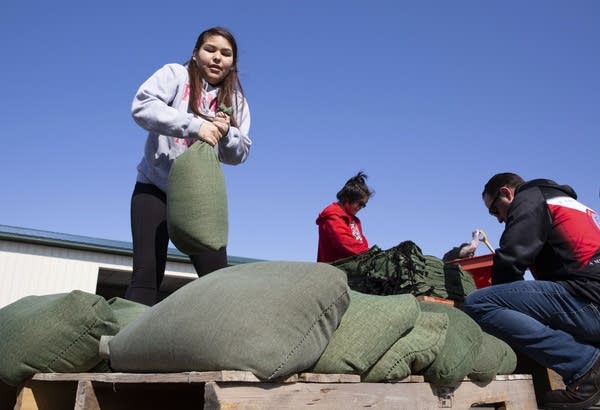 Laraina Franks, 15, helps fill sandbags.