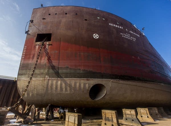 The Herbert C. Jackson dwarfs two workers.