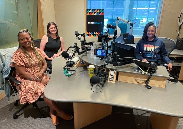 three women smiling in a broadcast studio