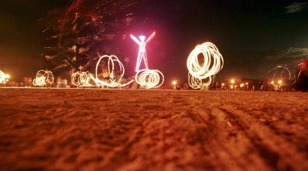 Dancers at the Burning Man festival create patterns with fireworks.