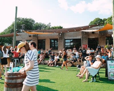 people enjoying live music and a happy hour outdoors