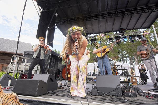 A band performing on an outdoor stage