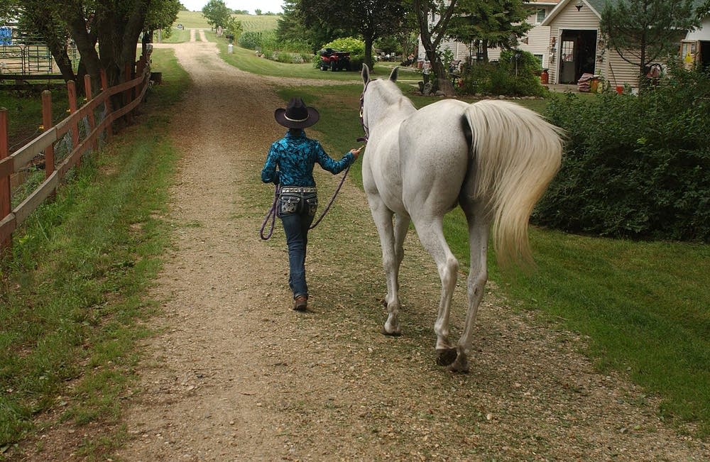 Walking her horse