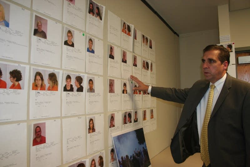 Sheriff Bob Fletcher points to a wall of mug shots