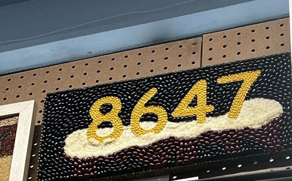 a piece of crop art says 8647