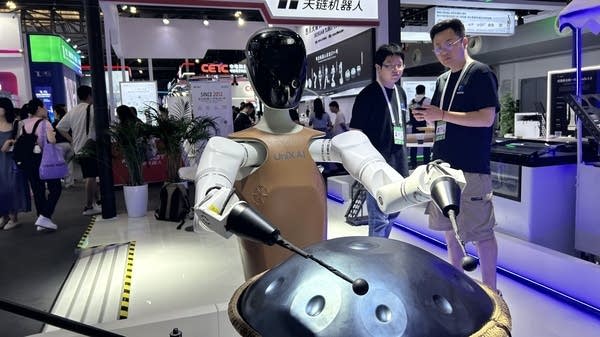 A humanoid plays a steel drum at the World AI Conference in Shanghai