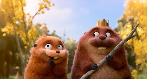 A screen grab of a movie with two animated beavers. One wears a crown.