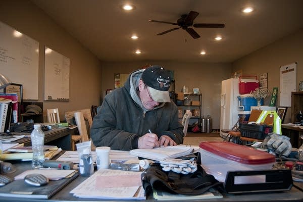 Breitkreutz does some paperwork in his office.