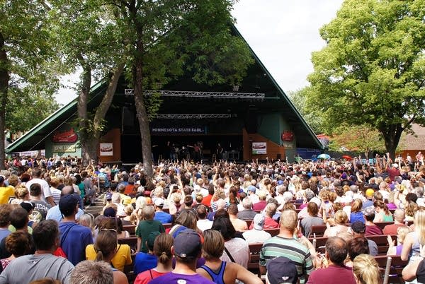 Photo of an exterior music venue with large audience during the day